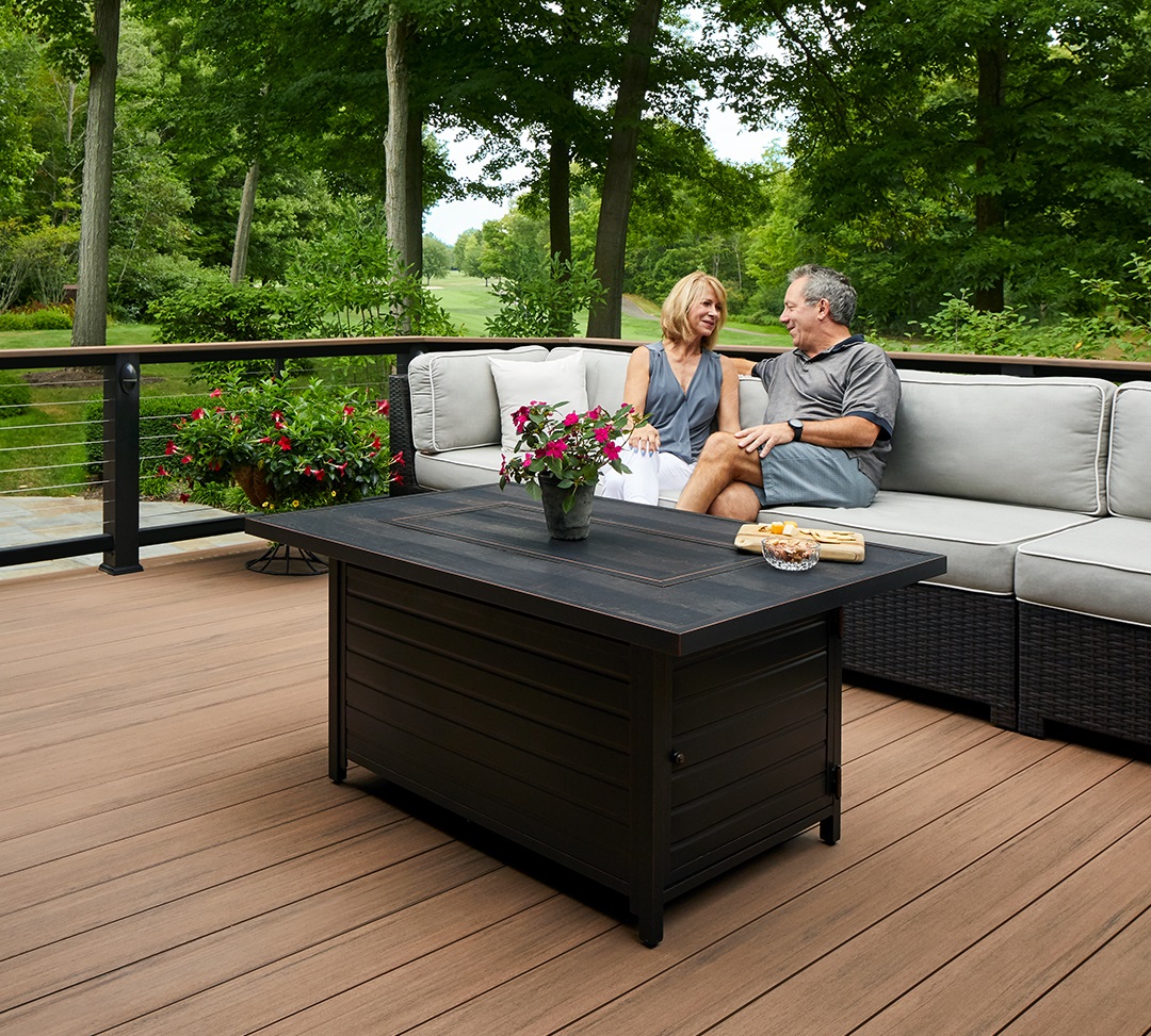 2 people sitting on couch outside on deck